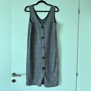 Plaid sleeveless dress with faux buttons.